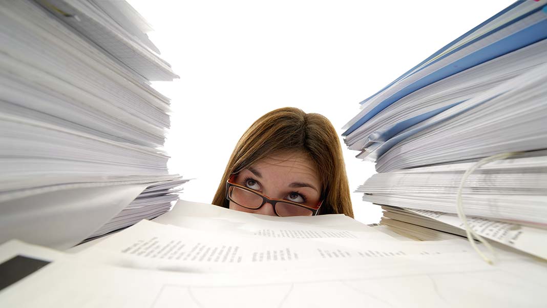 paper documentation system Office girl overwhelmed by piles of documents